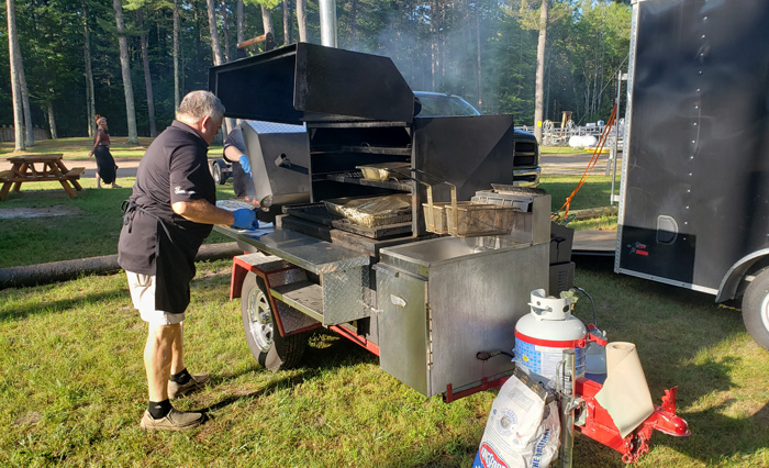 Man at bbq pit cooking wild game